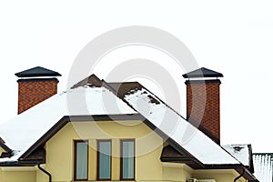 Low angle view of the upper floors of a new large house. Window and roof detail of residential home building. Real estate property