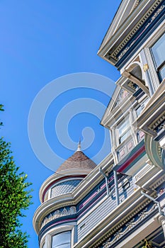 Low angle view of a victorian home with turret wall against the clear sky at San Francisco, CA