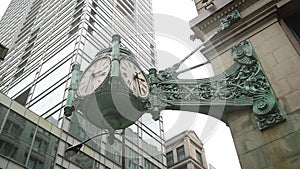 Low angle view of a vintage street clock on the side of a building, Chicago, USA