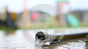 Low angle view of water flowing out the open end of a garden hose