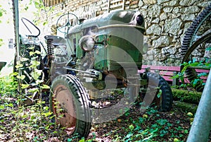 Low angle view of a well-preserved tractor in an abandoned place in the field