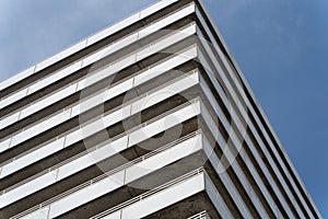 Low-angle view of a white building against a blue sky background