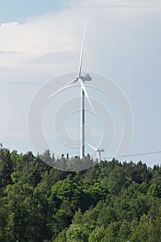 Low angle view of wind power against sky