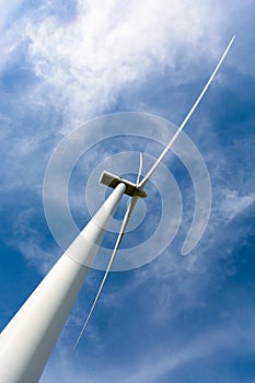 Low angle view of a wind turbine against blue sky