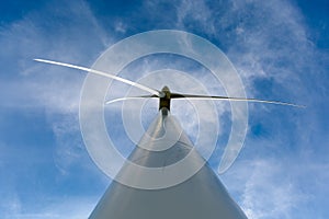 Low angle view of a wind turbine against blue sky