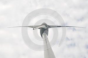 Low angle view of wind turbine against cloudy sky