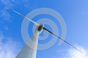 Low angle view of wind turbine producing alternative energy