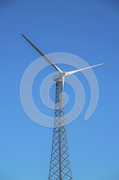 Low angle view of a windmill with lattice tower in a desert at California