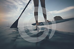 Low angle view of woman legs paddling
