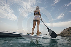 Low angle view of woman paddleboarding