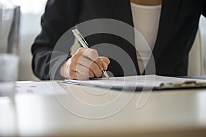 Low angle view of a woman signing contract