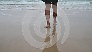 Low angle view of woman walking towards sea