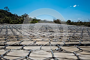 Low angle view of wooden boardwalk with mesh.