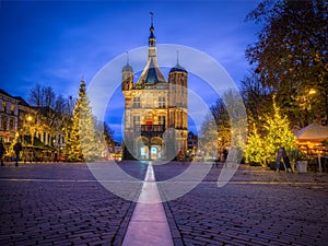 Low angle of the Waag gothic structure in Deventer, the Netherlands in an illuminated street