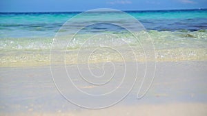 Low angle wave of clear ocean Maldives white sand slow motion