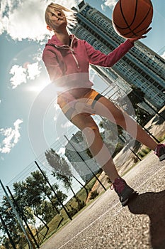 Low angle of a well built active woman photo