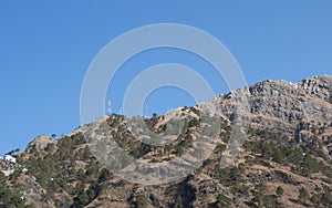 Low angle wide shot of a mountain top with telephone towers. Telecommunication concept