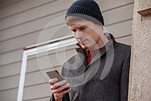 Intelligent man checking phone expressing interest