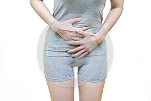 Low body of a woman in gray clothes put her hands on the Stomach area at spot of ache, abdominal pain, Health-care concept on