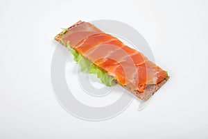 Low caloric open sandwich with red fish. Isolated on white background