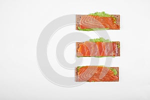 Low caloric open sandwich with red fish. Isolated on white background