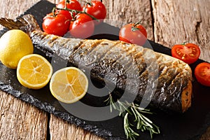 Low-calorie food of grilled pink salmon close-up on a slate board. horizontal