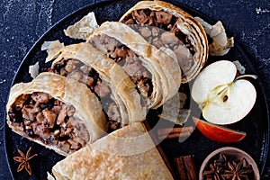 Low calorie pastry: apple strudel on a black plate