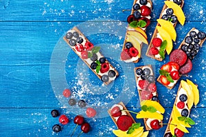 Low calorie summer sandwiches with creamy cheese and berry fruits top view. Easy snack for breakfast or lunch