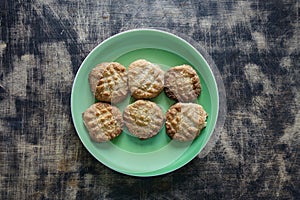 Keto cookies , green plate, wooden background photo