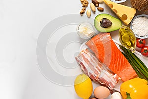 Low carb ketogenic diet with food rich with healthy fats and protein on white background. Top view with copy space