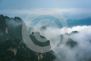 Low clouds engulfing stone pillars of Tianzi mountains in Zhangjiajie