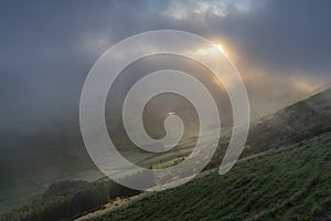 Low clouds over the Miradouro da Serra do Cume revealing the typical plots with walls landscape of Terceira