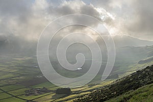 Low clouds over the Miradouro da Serra do Cume revealing the typical plots with walls landscape of Terceira photo