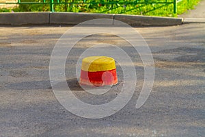 Low concrete posts forbidding cars from entering the sidewalk