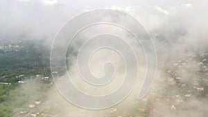 Low cumulus clouds over residential suburban cottages. Dense misty clouds over the picturesque eco-friendly area of