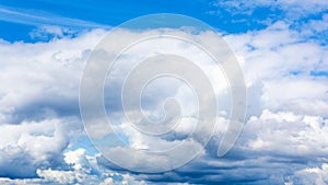 low cumulus white clouds in blue sky on summer day