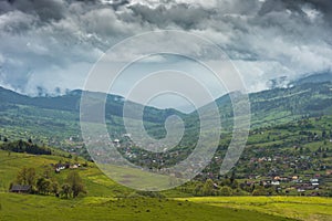 Low dramatic clouds over the mountain village