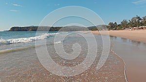 Low drone flight over the waves of Agonda beach. Goa State. India.