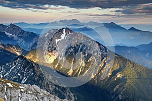 Low evening sunlight on ridges in hazy Karavanke / Kamnik Alps