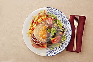 Low fat salad against greasy burger