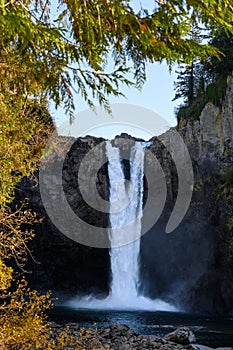 Low flow of water over Snoqualmie Falls on a sunny fall day