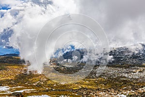 Low fluffy clouds descending over Snowy Mountains at Mount Kosciuszko National Park, Australia.