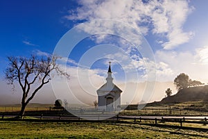 Low fog behind small rural church in Marin County, California at sunrise photo