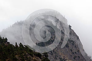Low fog blowing off the top of a rocky ledge, Fraser Canyon
