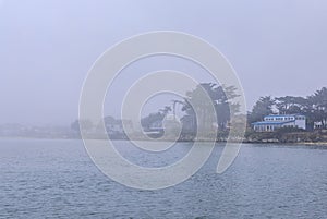 Low fog hanging over Pacific the Ocean in Pillar Point Half Moon Bay near San Francisco with coastline in the background