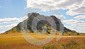 Low grass growing on African savanna, small rocky mountains in background - typical scenery at Isalo national Park, Madagascar