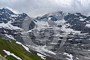 Low-hanging clouds above Eiger Gletscher and eternal snow in the Alps