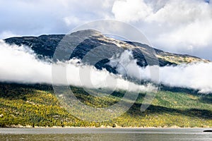 Low hanging clouds over mountainside coastline