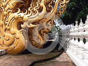 Low height Boundary wall and golden sculpture of Wat Rong Khun Chiang Rai