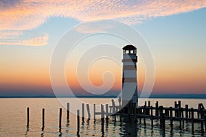 Low horizon romantic sunset sky over the lake landscape, Podersdorf Am See lighthouse